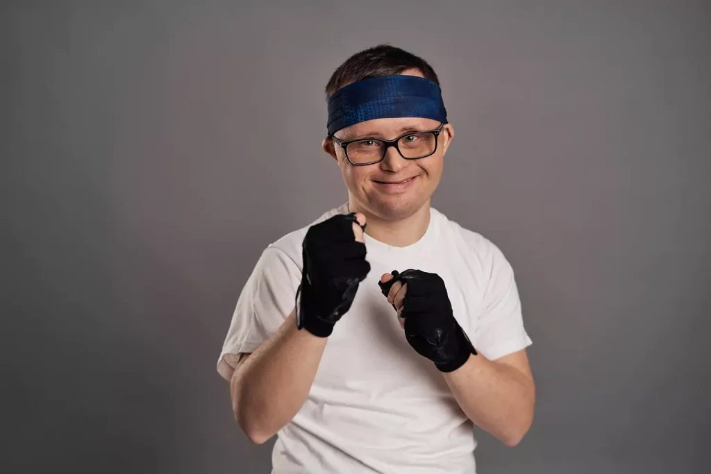 A disabled man smiling while doing the boxing pose