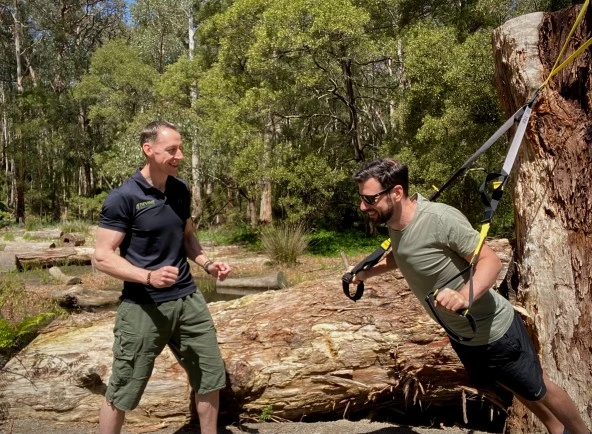 A man and his personal trainer doing exercise