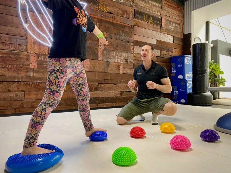 A girl and her personal trainer doing exercises